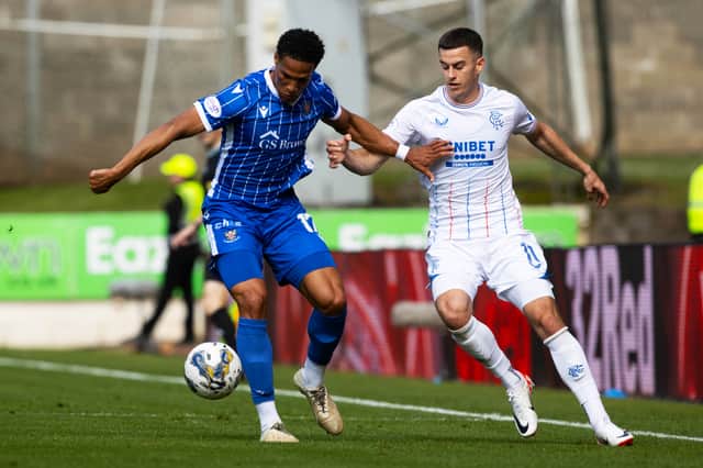 St Johnstone's Oludare Olufunwa and Rangers' Tom Lawrence in action 