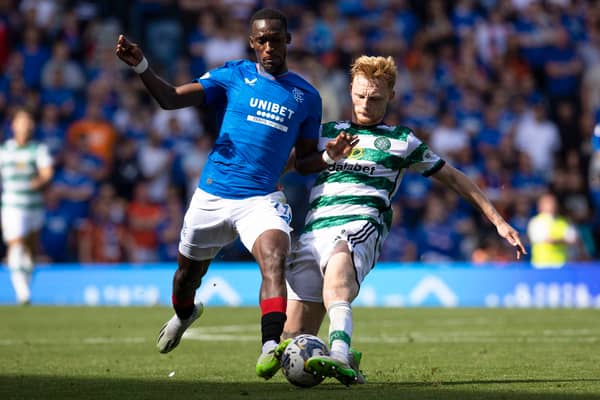 Celtic's Liam Scales and Rangers' Abdallah Sima in action at Ibrox
