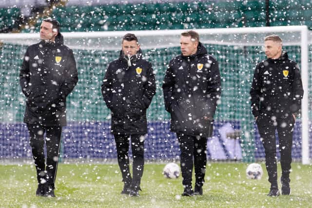  Referee Nick Walsh and the match officials check out the pitch