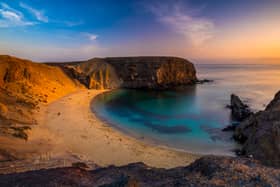 Romantic sunset over the beautiful, natural and sandy beach of Papagayo on Lanzarote