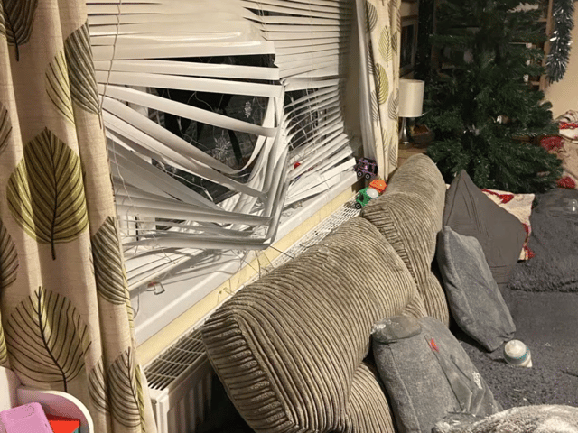 A family have been left "traumatised" after a "gift-wrapped brick" was thrown through their lounge window in the early hours of Christmas Day.