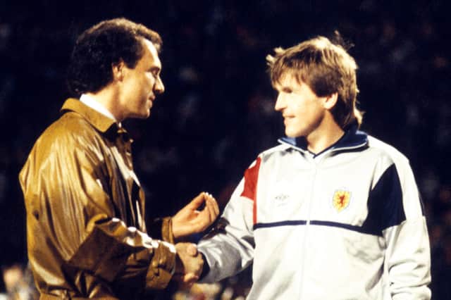 Franz Beckenbauer (left) presents Scotland's Kenny Dalglish with a trophy to commemorate his 100th cap