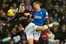 Rangers' James Tavernier (R) and Hearts' Andy Halliday (L)  contest a high ball