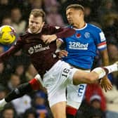 Rangers' James Tavernier (R) and Hearts' Andy Halliday (L)  contest a high ball