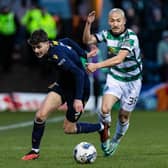 Dundee's Owen Beck (L) and Celtic's Daizen Maeda fight for the ball
