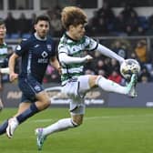 Celtic's Kyogo Furuhashi brings the ball down under pressure against Ross County