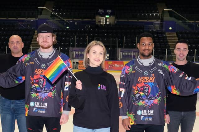 A Pride flag will be placed on every seat in Braehead Arena for the Clan game on Saturday night. Pictured are Clan players Alex Forbes, second left and Reece Kelly, fourth left along with Liam Stevenson, left, Claire Rankin, centre and Jordan Daly from the TIE charity.