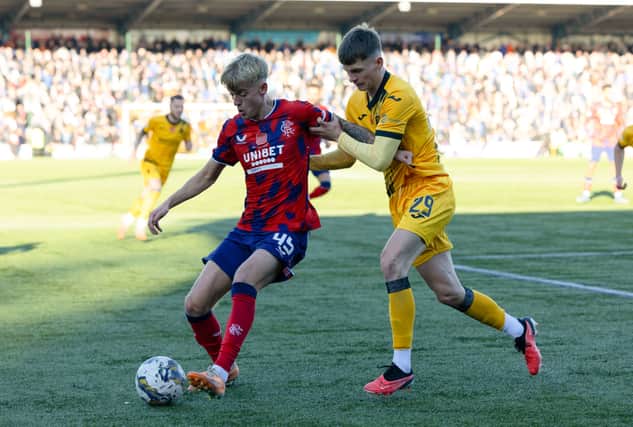 Rangers' Ross McCausland (L) and Livingston's James Penrice in action