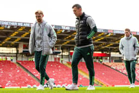 Celtic's Callum McGregor and Liam Scales check out the pitch