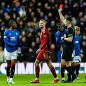 Referee Don Robertson shows Rangers' Dujon Sterling a red card for a tackle on Aberdeen's Jack MacKenzie