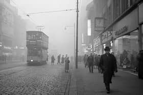 A tram rides down Argyle Street in the fog.