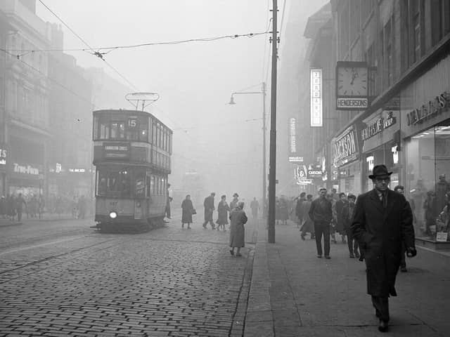 A tram rides down Argyle Street in the fog.