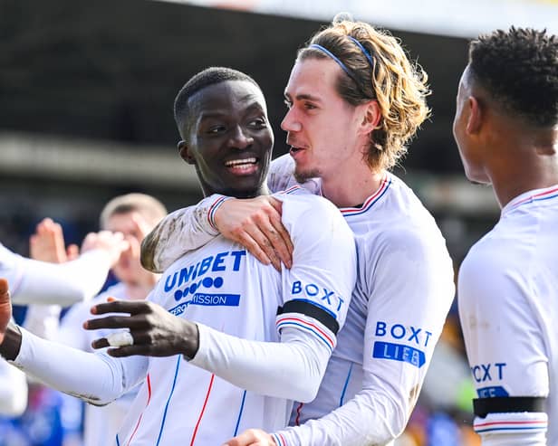 Mohamed Diomande celebrates his opening goal with Todd Cantwell. SNS.