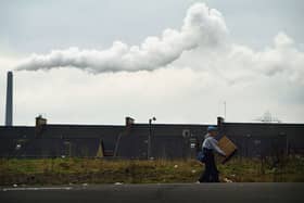 Walking along a street in Possil February 20, 2004 in Glasgow, Scotland. The Scottish Executive had announced plans to spend an extra £15million to tackle inequalities in Scotland's poorest areas.