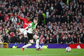 Amad Diallo of Manchester United scores his team's fourth goal whilst under pressure from Conor Bradley of Liverpool during the Emirates FA Cup Quarter Final