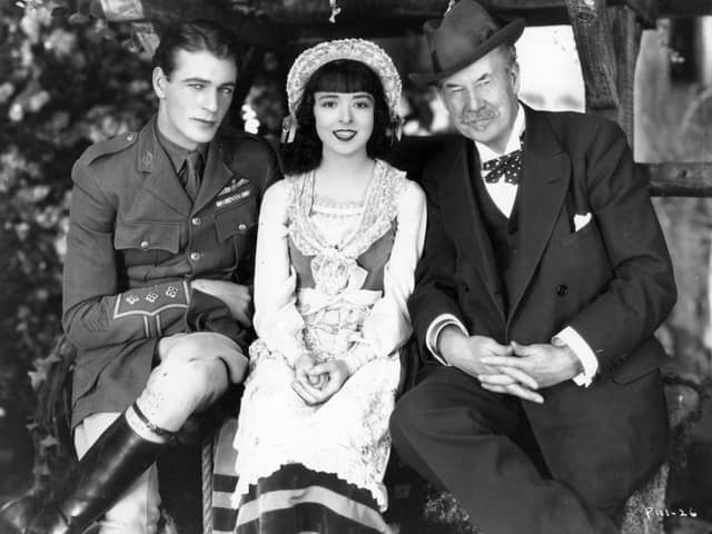 Sir Thomas Johnstone Lipton (1850 - 1931) the Scottish businessman and millionaire philanthropist is visiting Gary Cooper (1901 - 1961) and Colleen Moore (1900 - 1988), leading lady of the silent screen, on the production set of their latest film, 'Lilac Time' (aka 'Love Never Dies'). The film was directed by George Fitzmaurice for First National.  