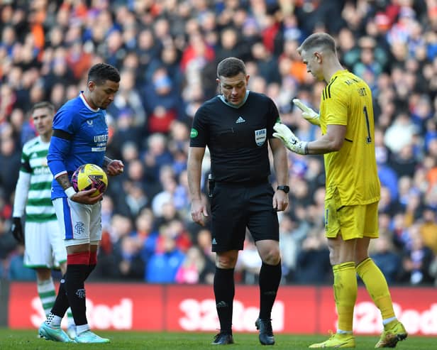 James Tavernier of Rangers (L), stands at the penalty spot with Joe Hart of Celtic and match referee John Beaton 