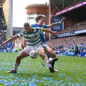 Celtic defender Cameron Carter-Vickers is challenged by Fabio Silva of Rangers as ticker tape litters the pitch at Ibrox