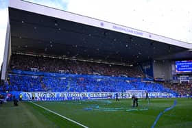 Rangers fans in the Broomloan stand throw ticker tape and wave flags before kick-off against Celtic