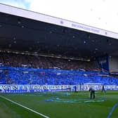 Rangers fans in the Broomloan stand throw ticker tape and wave flags before kick-off against Celtic