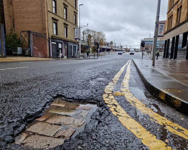 The pothole on Oswald Street reveals the old cobbled street below the modern tarmac.