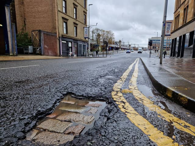 The pothole on Oswald Street reveals the old cobbled street below the modern tarmac.