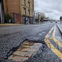 The pothole on Oswald Street reveals the old cobbled street below the modern tarmac.