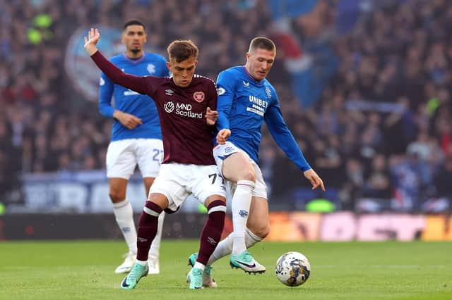 Kenneth Vargas of Heart of Midlothian and John Lundstram of Rangers battle for possession