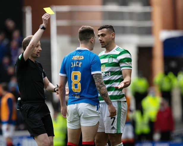 Celtic's Giorgos Giakoumakis is shown a yellow card by referee Willie Collum for a foul on Rangers' Ryan Jack 