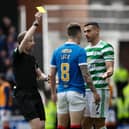 Celtic's Giorgos Giakoumakis is shown a yellow card by referee Willie Collum for a foul on Rangers' Ryan Jack 