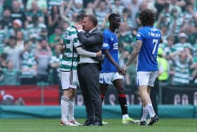 Callum McGregor of Celtic and Brendan Rodgers, Manager of Celtic, embrace following the team's victory