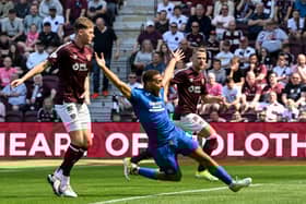 Rangers' Cyriel Dessers goes down in the box under the challenge of Hearts' Frankie Kent 