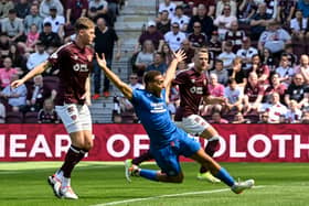 Rangers' Cyriel Dessers goes down in the box under the challenge of Hearts' Frankie Kent 