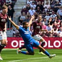 Rangers' Cyriel Dessers goes down in the box under the challenge of Hearts' Frankie Kent 