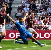 Rangers' Cyriel Dessers goes down in the box under the challenge of Hearts' Frankie Kent 