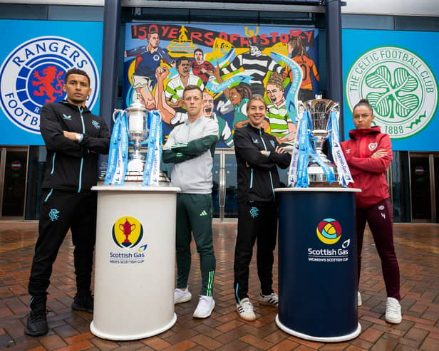 The four captains pose in front of the mural at Hampden.