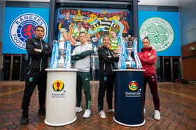 The four captains pose in front of the mural at Hampden.