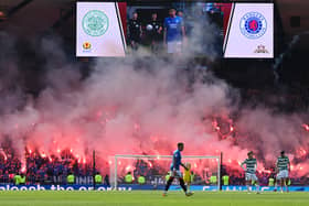 Rangers supporters greet the two teams for the second half with a display of flares during the Scottish Cup final against Celtic