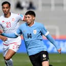 Tunisia's forward Jebril Othman (L) and Uruguay's midfielder Damian Garcia vie for the ball 
