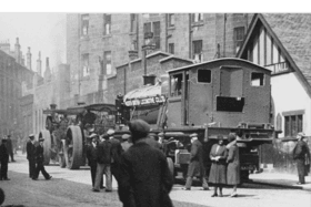 A North British Locomotive engine being transported through the streets of Springburn