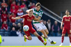 Aberdeen's Connor Barron (L) and Celtic's Paulo Bernardo in action