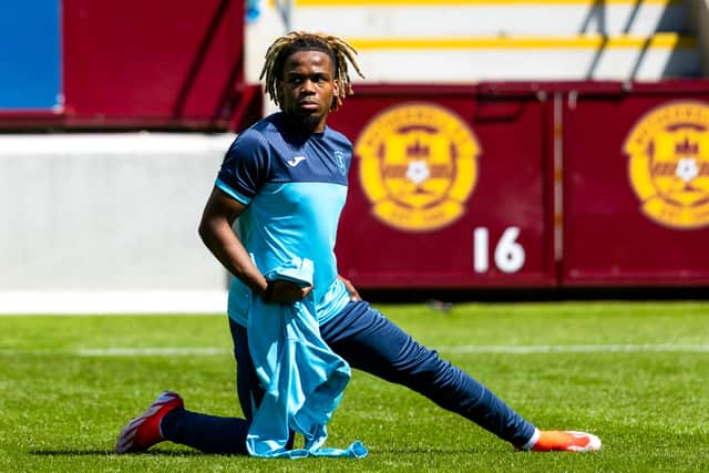 Livingston trialist Dapo Mebude warms up ahead of a pre-season friendly match against Motherwell at Fir Park