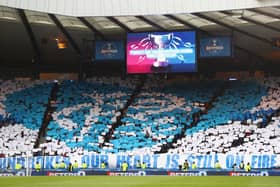 Rangers supporters unveil a mosaque displaying the club crest 