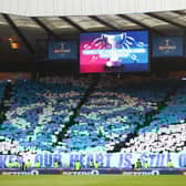 Rangers supporters unveil a mosaque displaying the club crest 