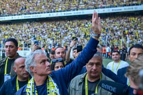 New manager of Turkish club Fenerbahce Jose Mourinho (C) waves during the presentation to the supporters at the Sukru Saracoglu Stadium in Istanbul