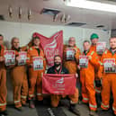 Offshore workers at Ninian Central platform with posters backing Unite the Union's No Ban Without a Plan campaign.