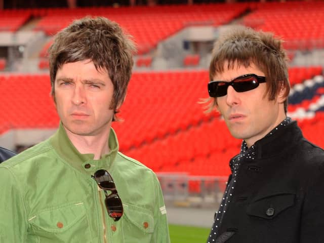 Oasis band members Noel (left) and Liam Gallagher are pictured during a photo call at Wembley Stadium. 