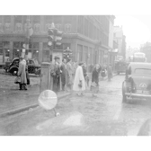 Pedestrians crossing the road on Bath Street at the intersection with Renfield Street. The Transport Department Offices are pictured in the background. 