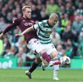 Nathaniel Atkinson of Hearts vies with Daizen Maeda of Celtic