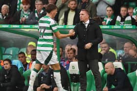 Arne Engels of Celtic reacts with his manager Brendan Rodgers after scoring against Hearts